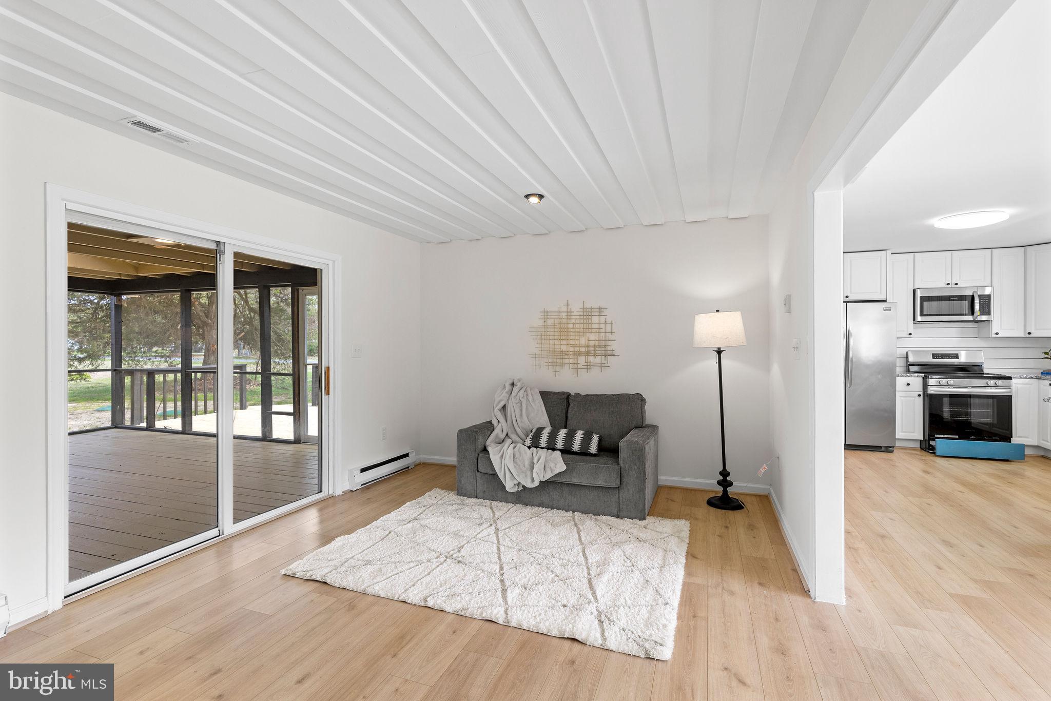 6749 Eldorado Road Federalsburg, MD 21632 - Photo 11 of 39 a spacious bedroom with a bed and wooden floor