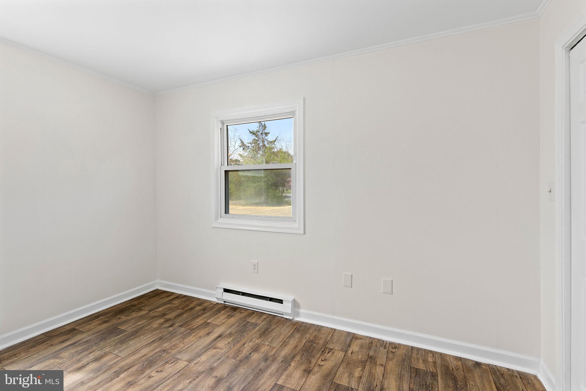 6749 Eldorado Road Federalsburg, MD 21632 - Photo 18 of 39 a view of an empty room with wooden floor and a window