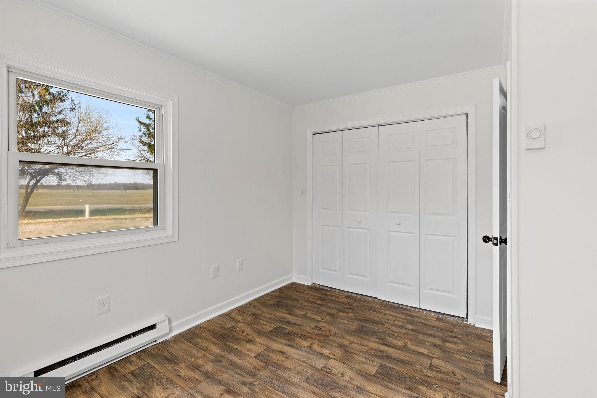 6749 Eldorado Road Federalsburg, MD 21632 - Photo 19 of 39 a view of empty room with window and wooden floor