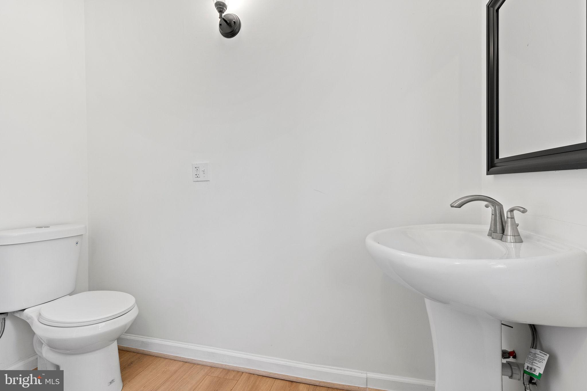 6749 Eldorado Road Federalsburg, MD 21632 - Photo 25 of 39 a bathroom with a sink a toilet and mirror