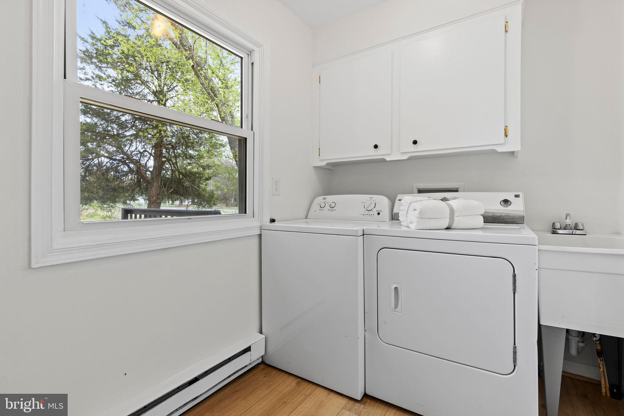 6749 Eldorado Road Federalsburg, MD 21632 - Photo 26 of 39 a utility room with cabinets washer and dryer