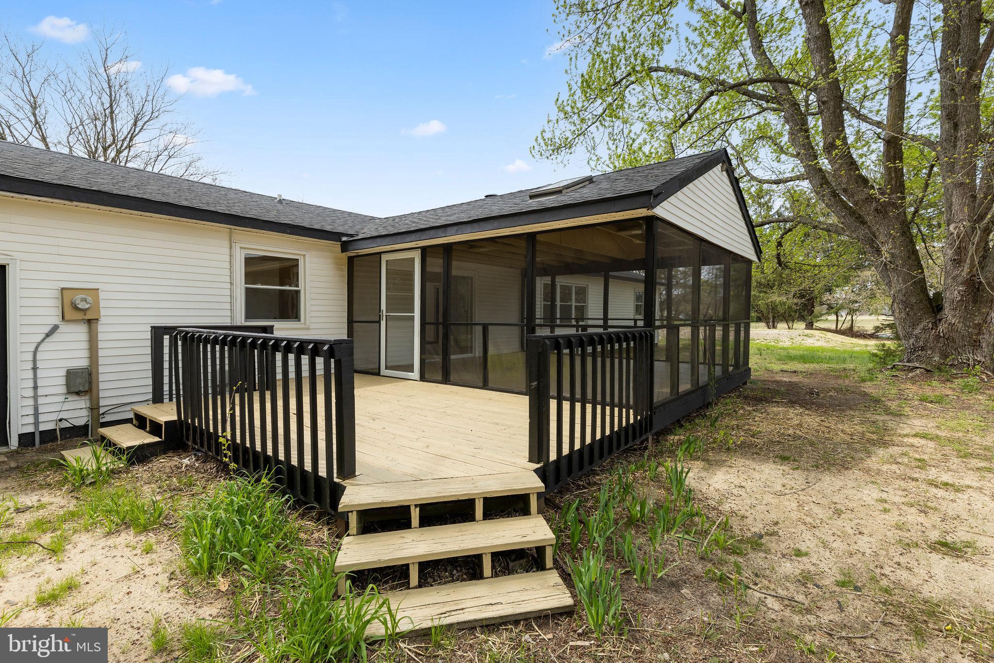6749 Eldorado Road Federalsburg, MD 21632 - Photo 30 of 39 a view of a house with wooden fence and a porch