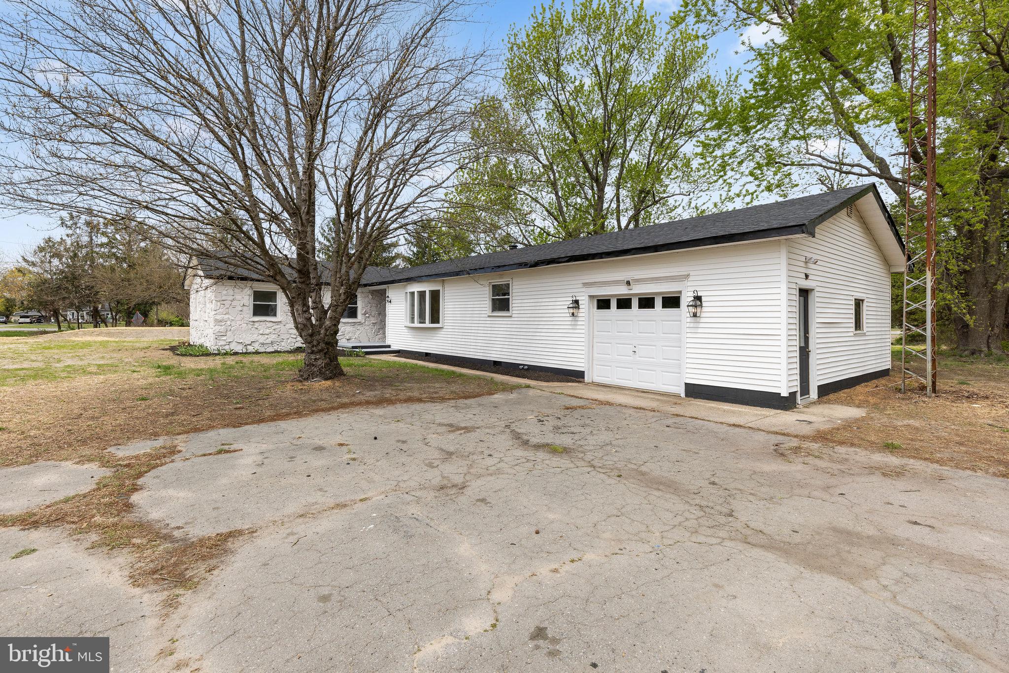 6749 Eldorado Road Federalsburg, MD 21632 - Photo 6 of 39 a white house that has a tree in front of it