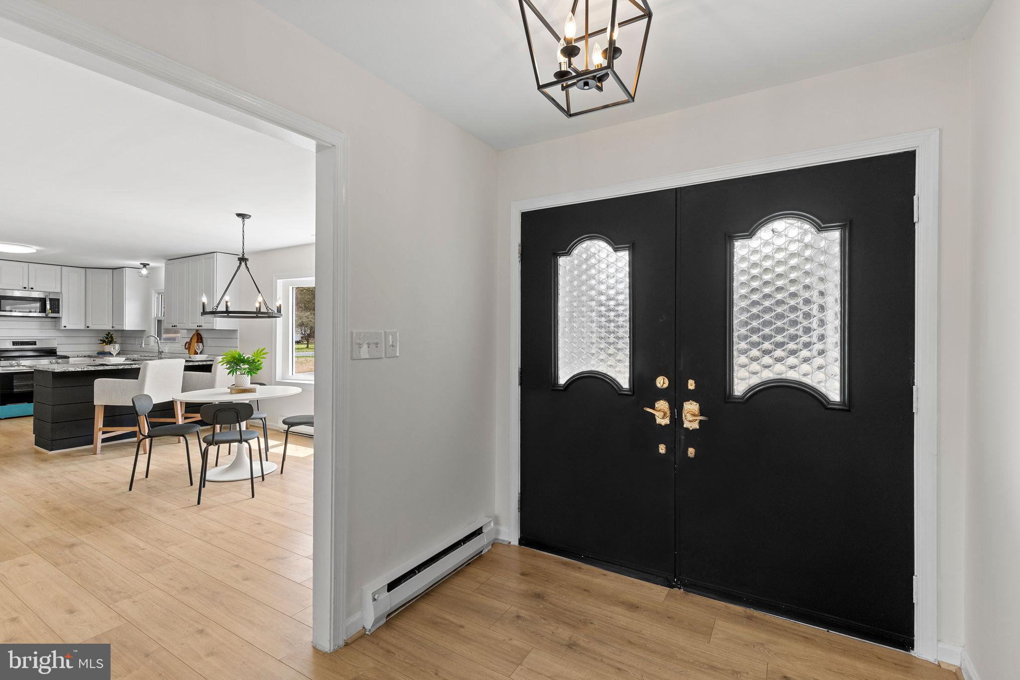 6749 Eldorado Road Federalsburg, MD 21632 - Photo 8 of 39 a view of a hallway with dining room and wooden floor