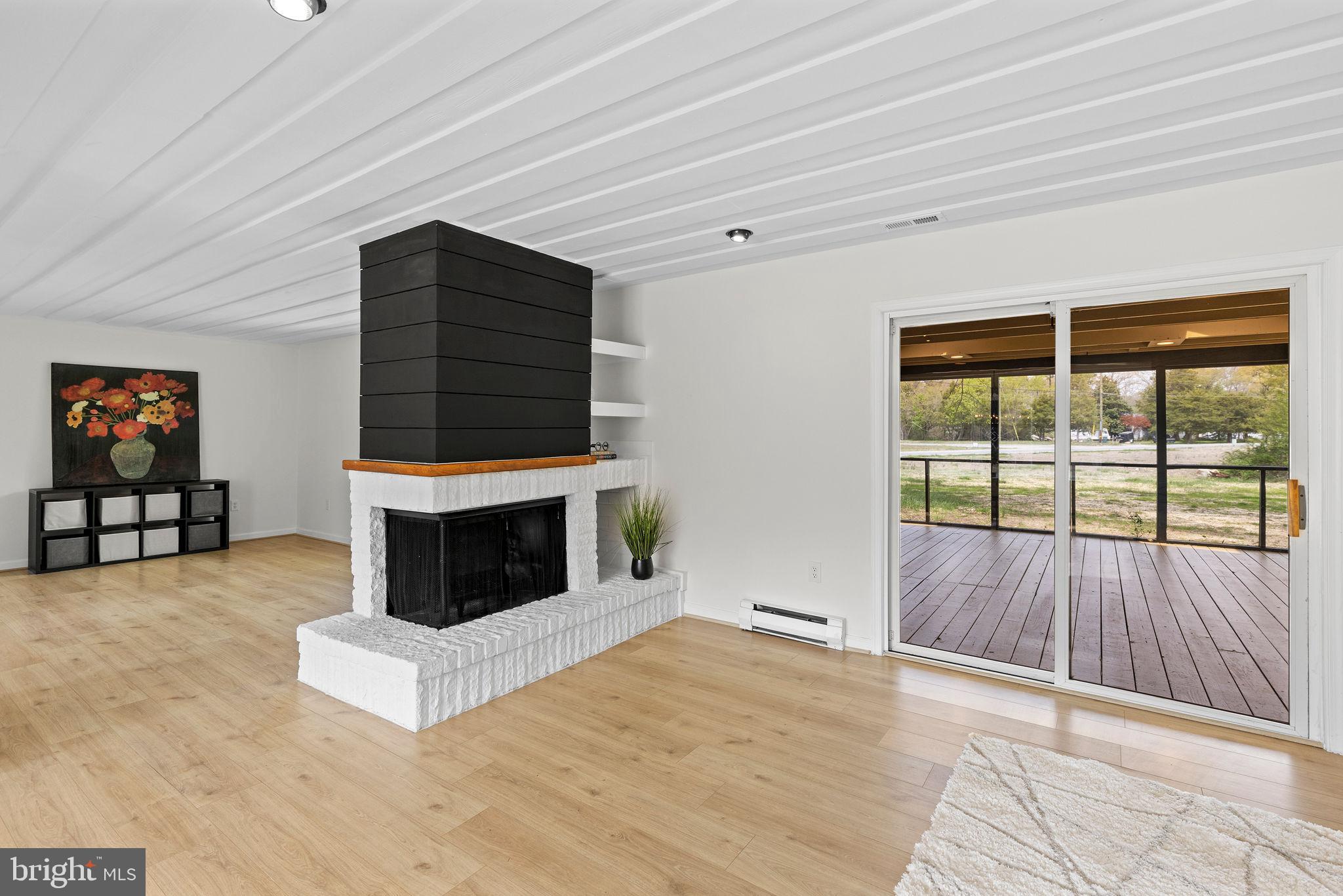 6749 Eldorado Road Federalsburg, MD 21632 - Photo 9 of 39 a living room with furniture and a fireplace
