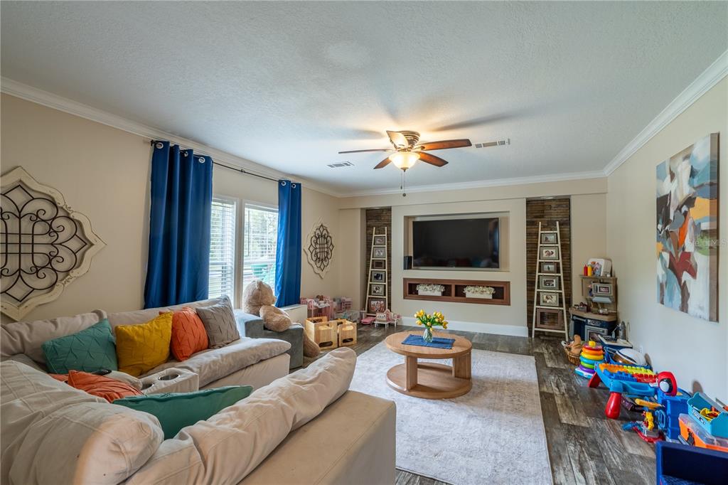 1508 East Winnetka Street Hernando, FL 34442 - Photo 11 of 55 a living room with furniture and a flat screen tv
