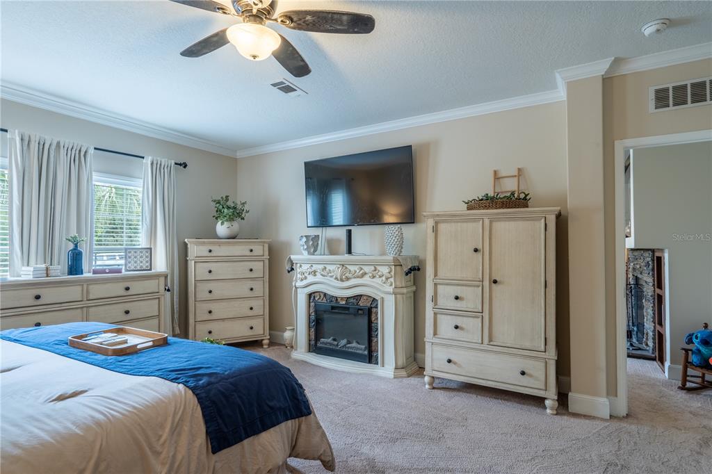 1508 East Winnetka Street Hernando, FL 34442 - Photo 14 of 55 a bedroom with a bed and a fireplace