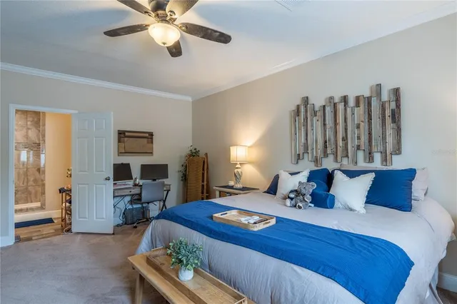 a bedroom with a bed and a chandelier