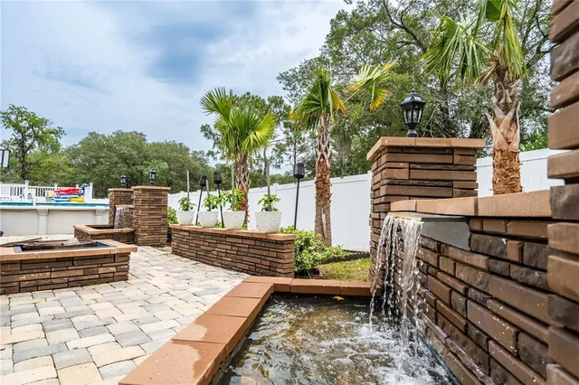 a view of a patio with table and chairs with wooden floor and fence