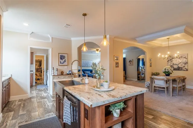 a large kitchen with kitchen island a table and chairs