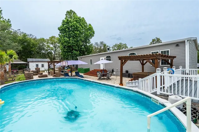 a view of a patio with table and chairs under an umbrella