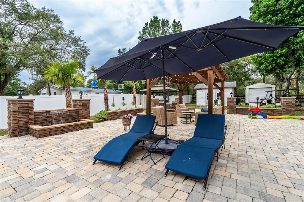 1508 East Winnetka Street Hernando, FL 34442 - Photo 33 of 55 a view of a patio with table and chairs under an umbrella