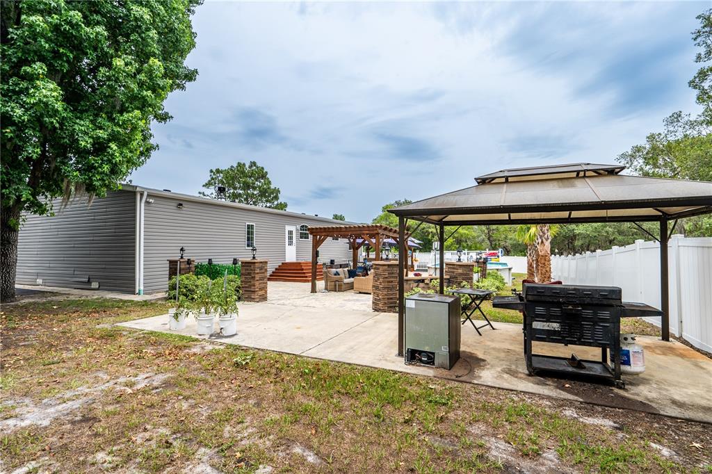 1508 East Winnetka Street Hernando, FL 34442 - Photo 36 of 55 an outdoor space with furniture and umbrella