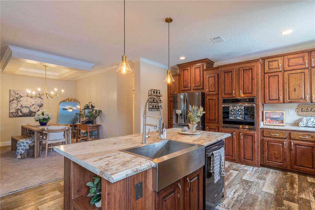 1508 East Winnetka Street Hernando, FL 34442 - Photo 4 of 55 a kitchen with kitchen island granite countertop a table chairs sink and cabinets
