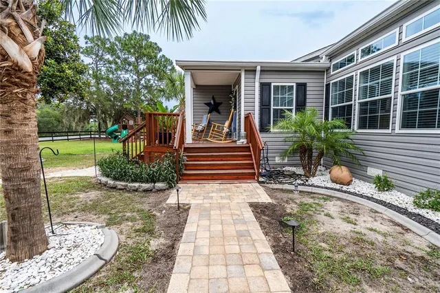 a view of a house with backyard porch and sitting area