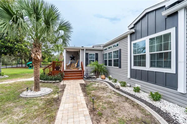 a house view with a sitting space and garden