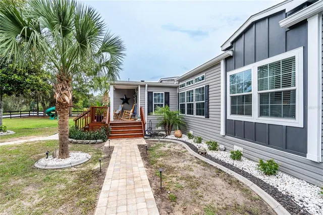 a house view with a sitting space and garden