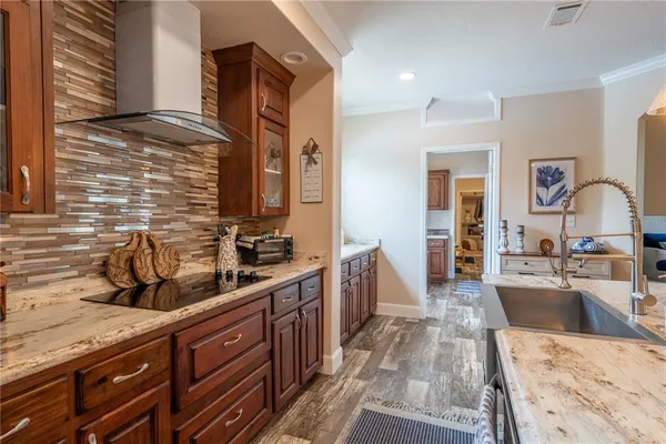 a kitchen with stainless steel appliances granite countertop a sink stove and refrigerator