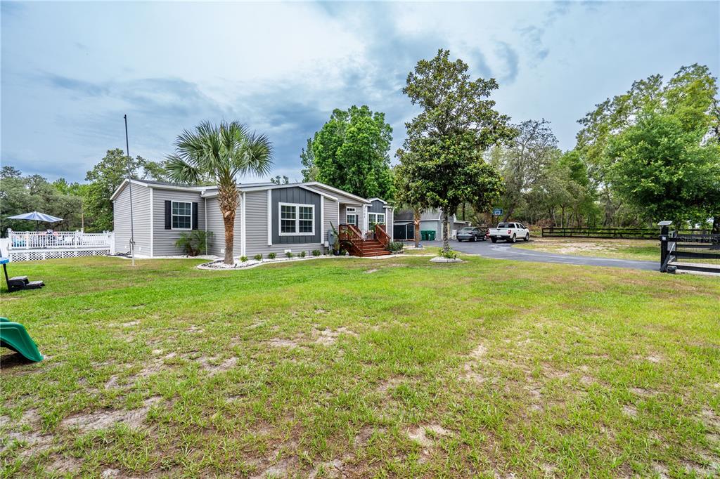 1508 East Winnetka Street Hernando, FL 34442 - Photo 52 of 55 a front view of house with yard and trees in the background