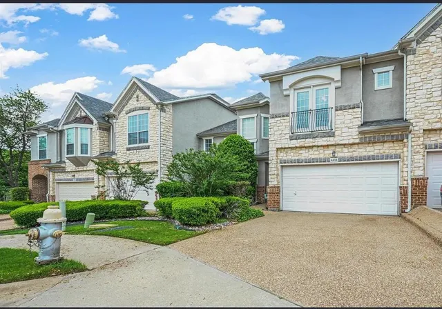 a front view of a house with a garden and plants
