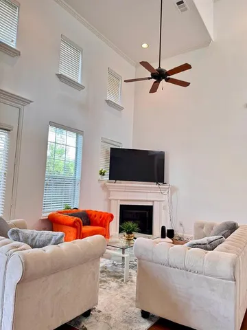 a living room with furniture a fireplace and a flat screen tv