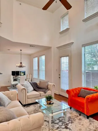 a bedroom with furniture and a large window