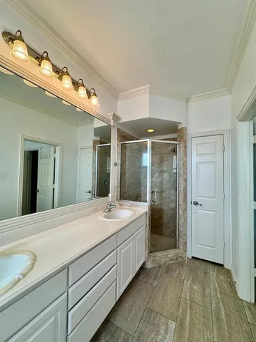 a bathroom with a shower sink and mirror