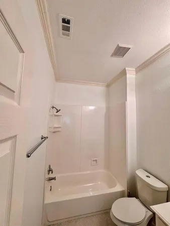 a bathroom with a toilet and a bathtub
