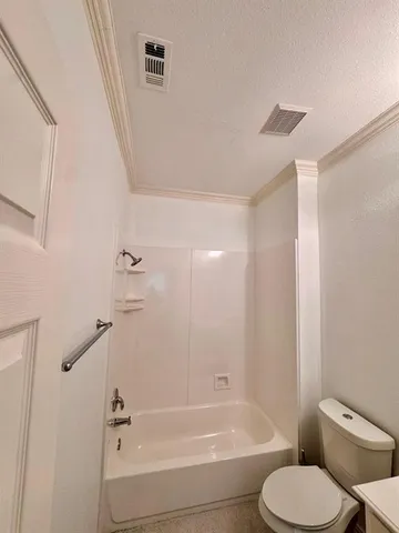 a bathroom with a toilet and a bathtub