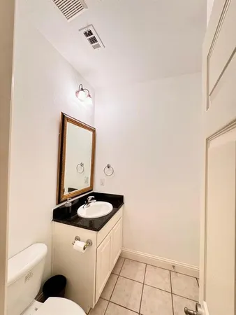 a bathroom with a sink a toilet and mirror