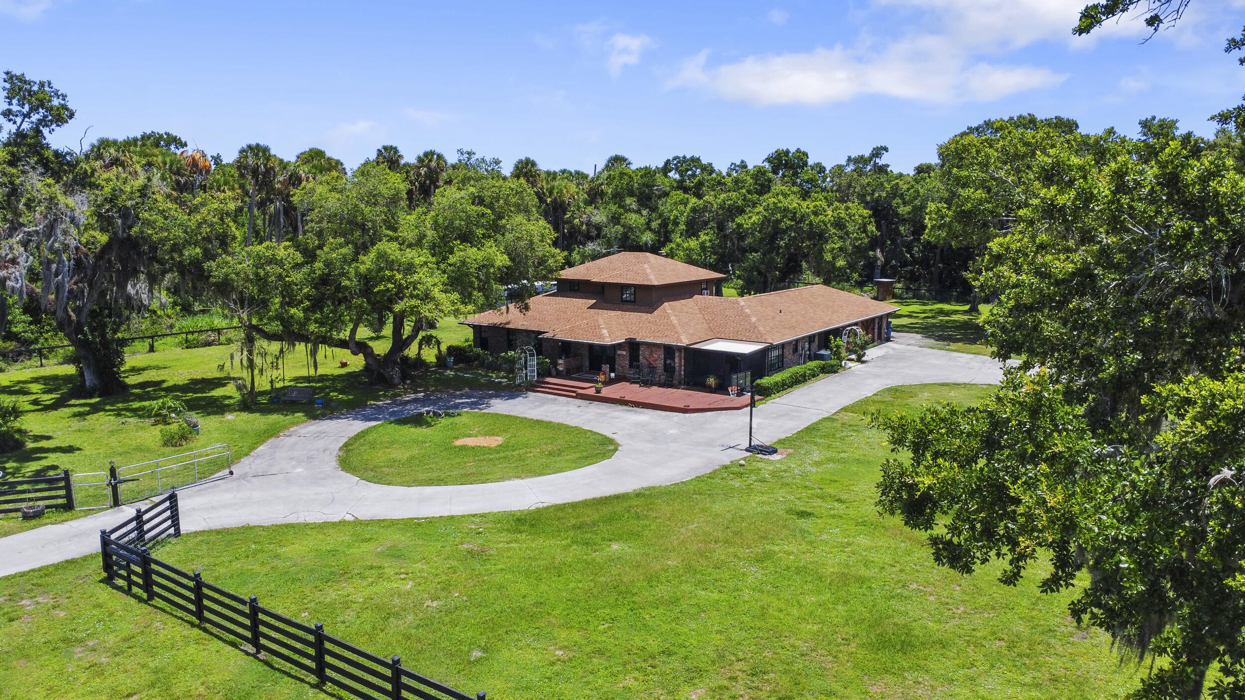 a aerial view of a house with yard and green space