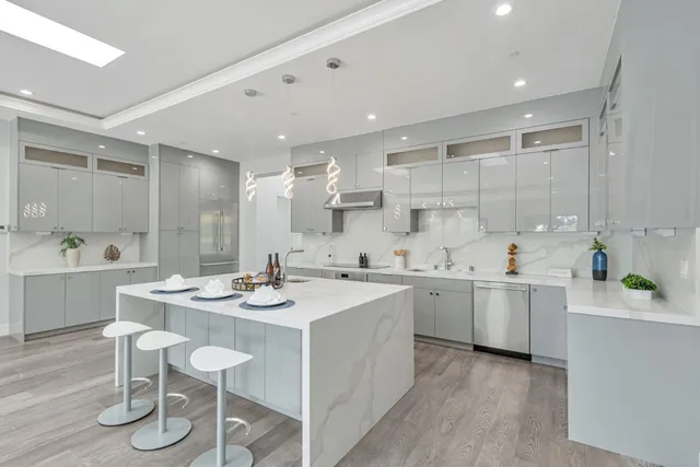 a kitchen with stainless steel appliances granite countertop a sink stove and cabinets