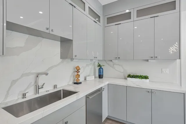 a living room with furniture floor to ceiling window and wooden floor