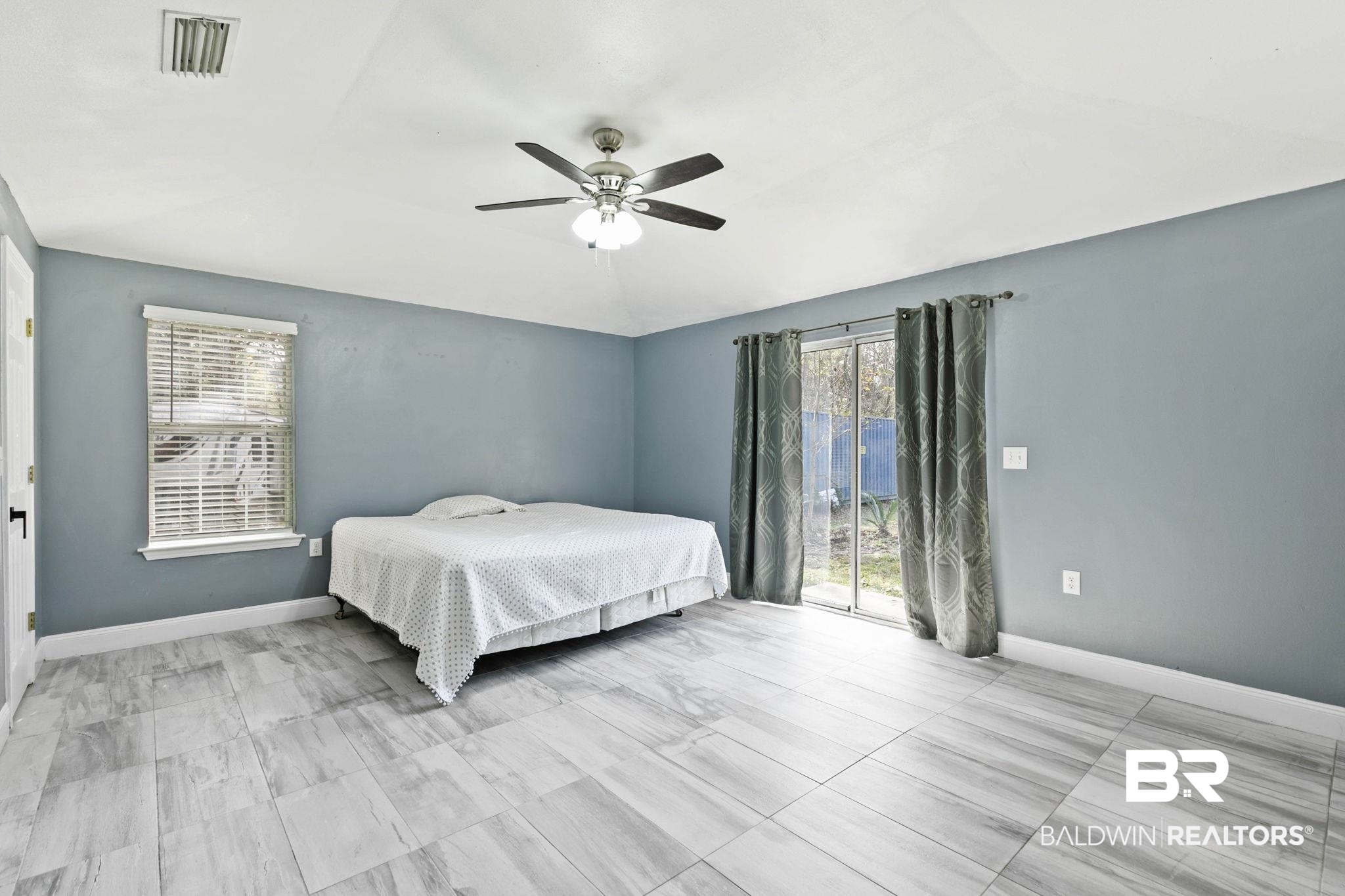 17366 Old Brady Road Bay Minette, AL 36507 - Photo 15 of 43 Bedroom featuring access to outside, ceiling fan, and vaulted ceiling