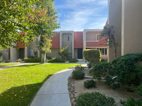 a front view of a house with swimming pool garden and outdoor seating