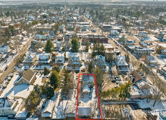 an aerial view of residential houses with city view