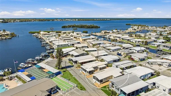 an aerial view of a building with garden space and ocean view
