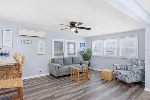 a living room with furniture and wooden floor