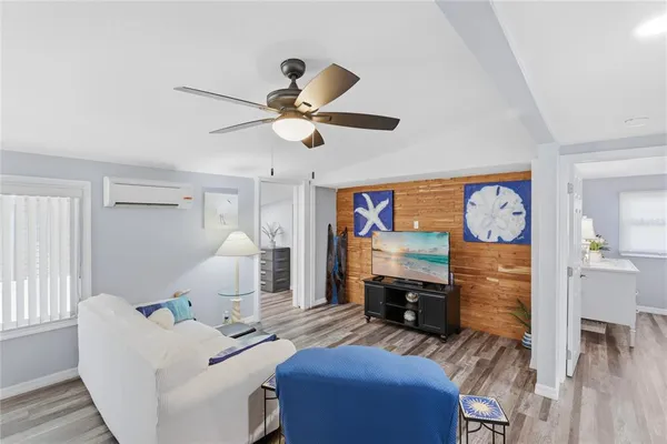 a living room with furniture and a flat screen tv