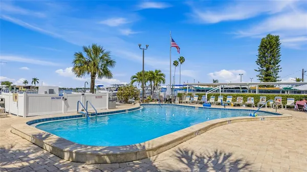 a view of a swimming pool with outdoor seating