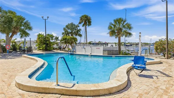 a view of a swimming pool with outdoor seating