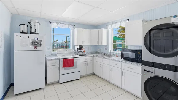 a kitchen with a refrigerator sink and cabinets