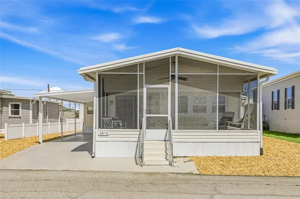 a view of a house with a wooden fence