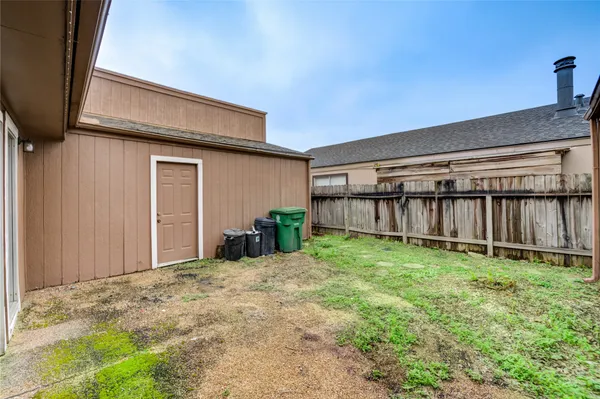 a view of a house with backyard and sitting area