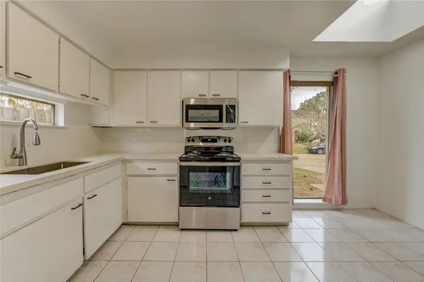 a kitchen with cabinets and appliances