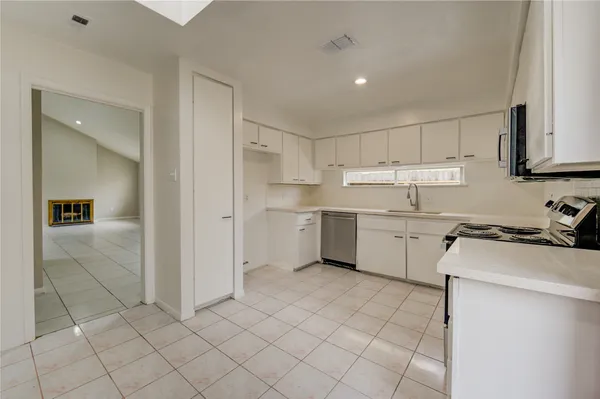a kitchen with a stove a sink and a refrigerator