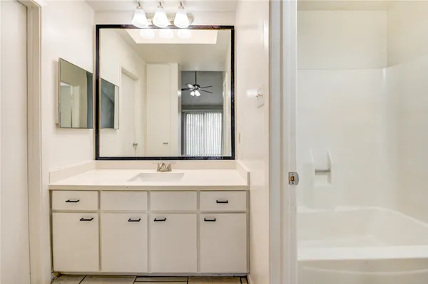 a bathroom with a bathtub and a mirror