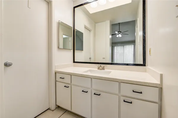 a bathroom with a double vanity sink and mirror