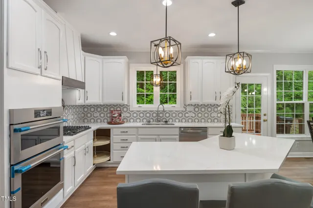 a kitchen with a stove and a chandelier