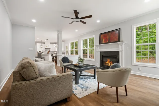 a living room with furniture fireplace and a table